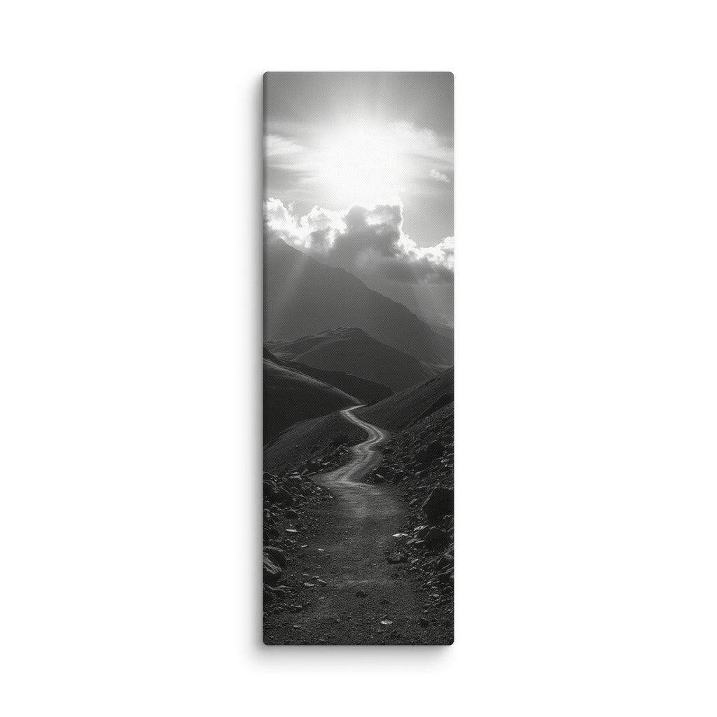 The Silent Ascent, tall wrapped canvas print: a black-and-white winding mountain path climbing toward sunlight breaking through clouds.