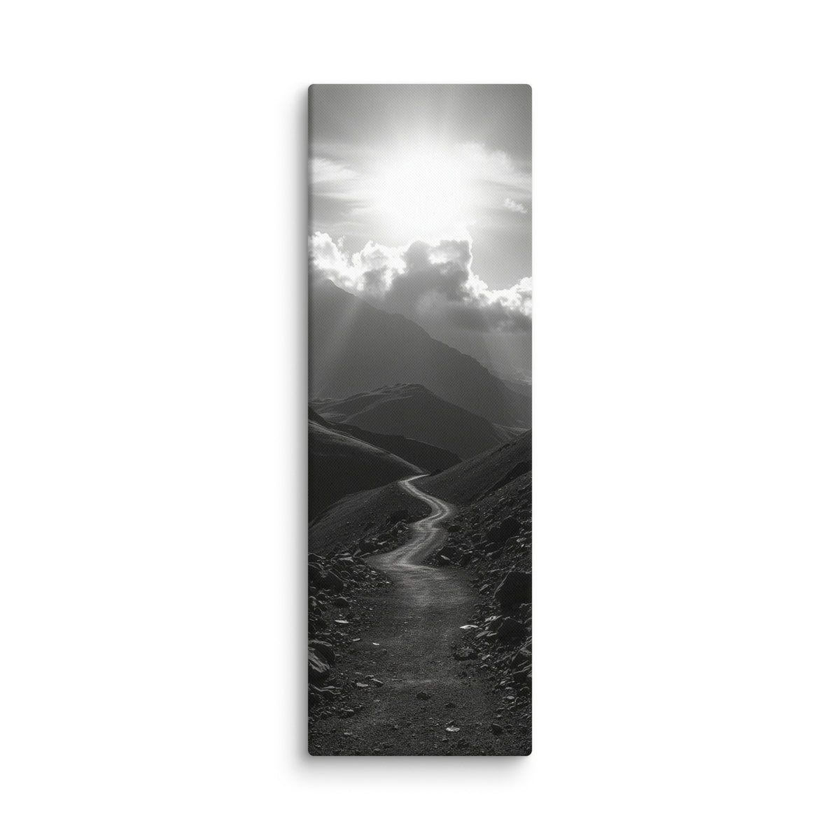 The Silent Ascent, tall wrapped canvas print: a black-and-white winding mountain path climbing toward sunlight breaking through clouds.