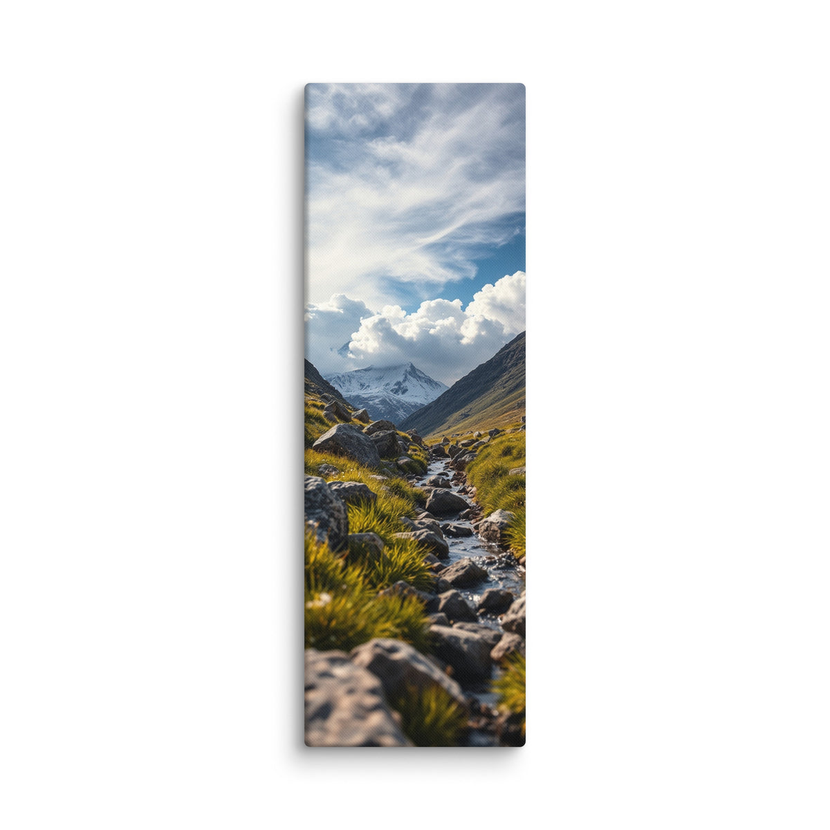 Where The Snow Begins, tall wrapped canvas print: a stream crossing a green alpine meadow toward snow-capped peaks under swirling clouds.