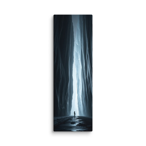 A Blade Of Light, tall wrapped canvas print: a vertical shaft of icy light cutting through a dark slot canyon with a lone figure.