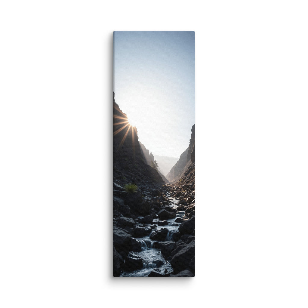 First Light In The Cleft, tall wrapped canvas print: the sun bursting over a dark rocky cleft as a stream flows toward the light.