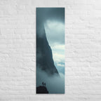Beside the Mountain Wall, tall wrapped canvas print: two small figures on a rocky ledge beside a towering mist-shrouded mountain wall.