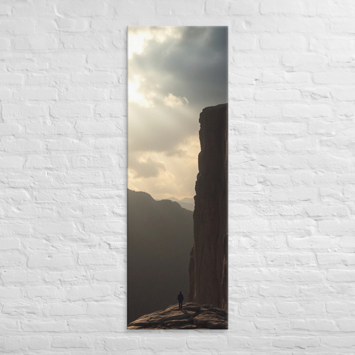 The Sunlit Shelf, tall wrapped canvas print: a lone figure on a sun-warmed rock shelf beside a towering cliff wall.