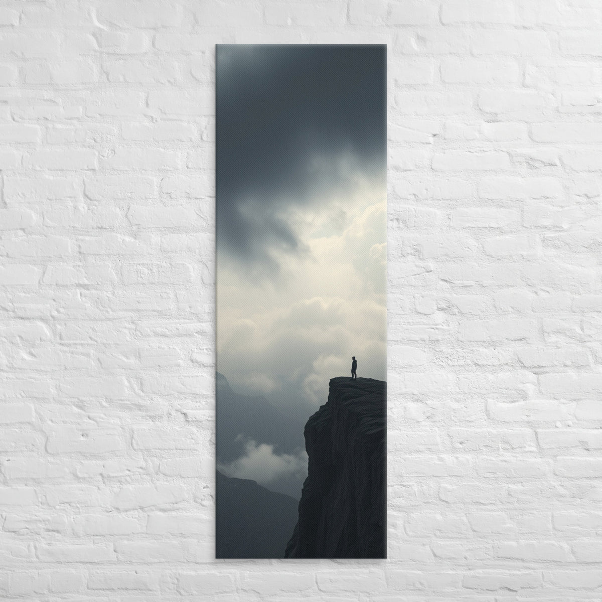 Where the Clouds Break, tall wrapped canvas print: a lone figure on a high cliff as dark clouds split open with light behind.
