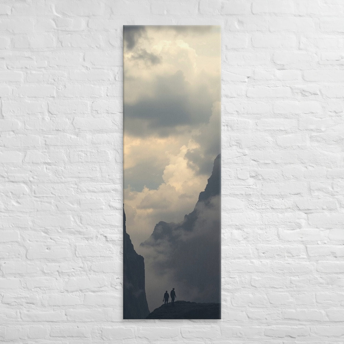 The Valley of Clouds, tall wrapped canvas print: two figures on a ridge between dark peaks above a valley filled with cloud.