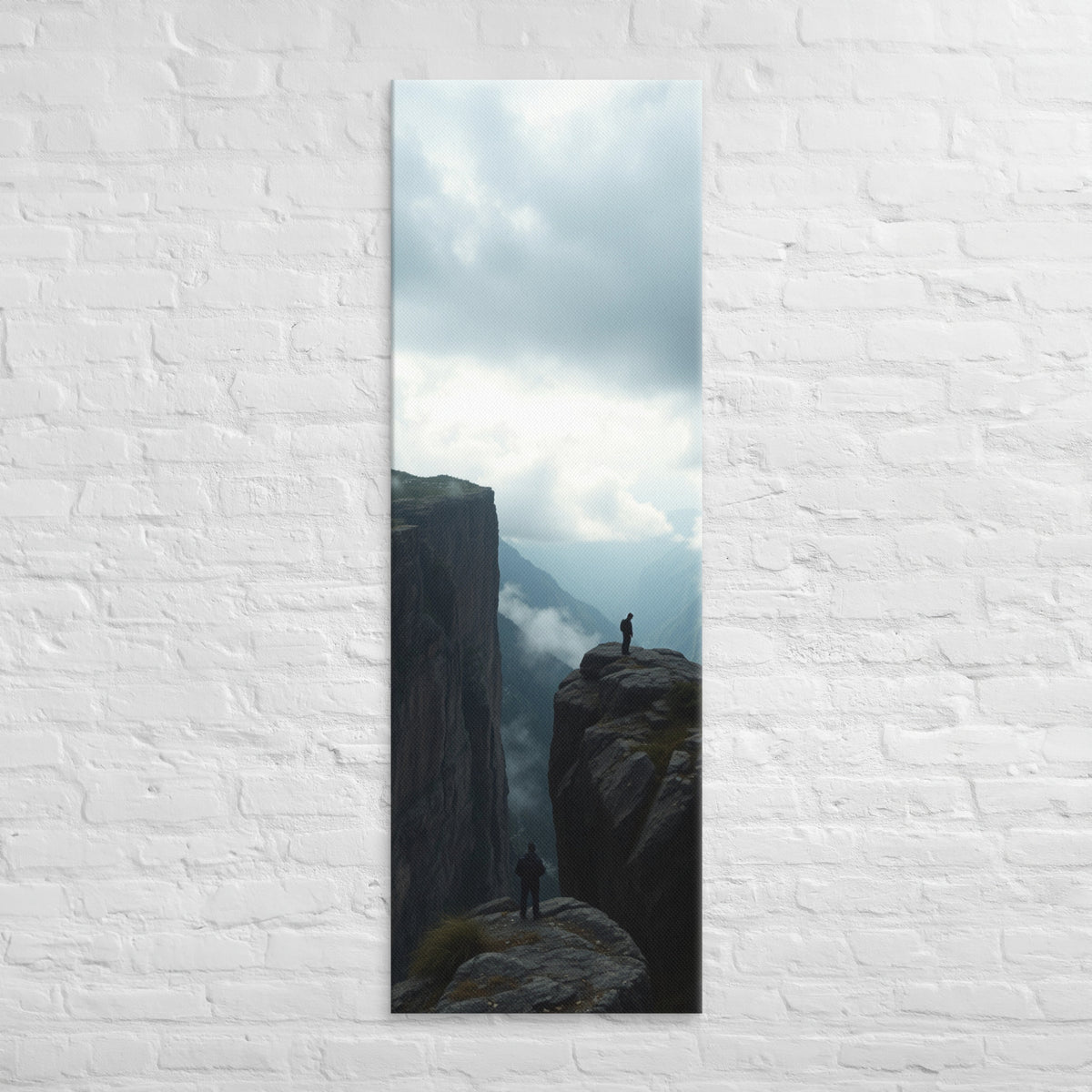 Across the Divide, tall wrapped canvas print: two figures on separate rocky outcrops with a misty mountain divide between them.