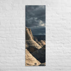 Among the Sandstone Folds, tall wrapped canvas print: two figures among pale wave-folded sandstone formations under a dark sky.