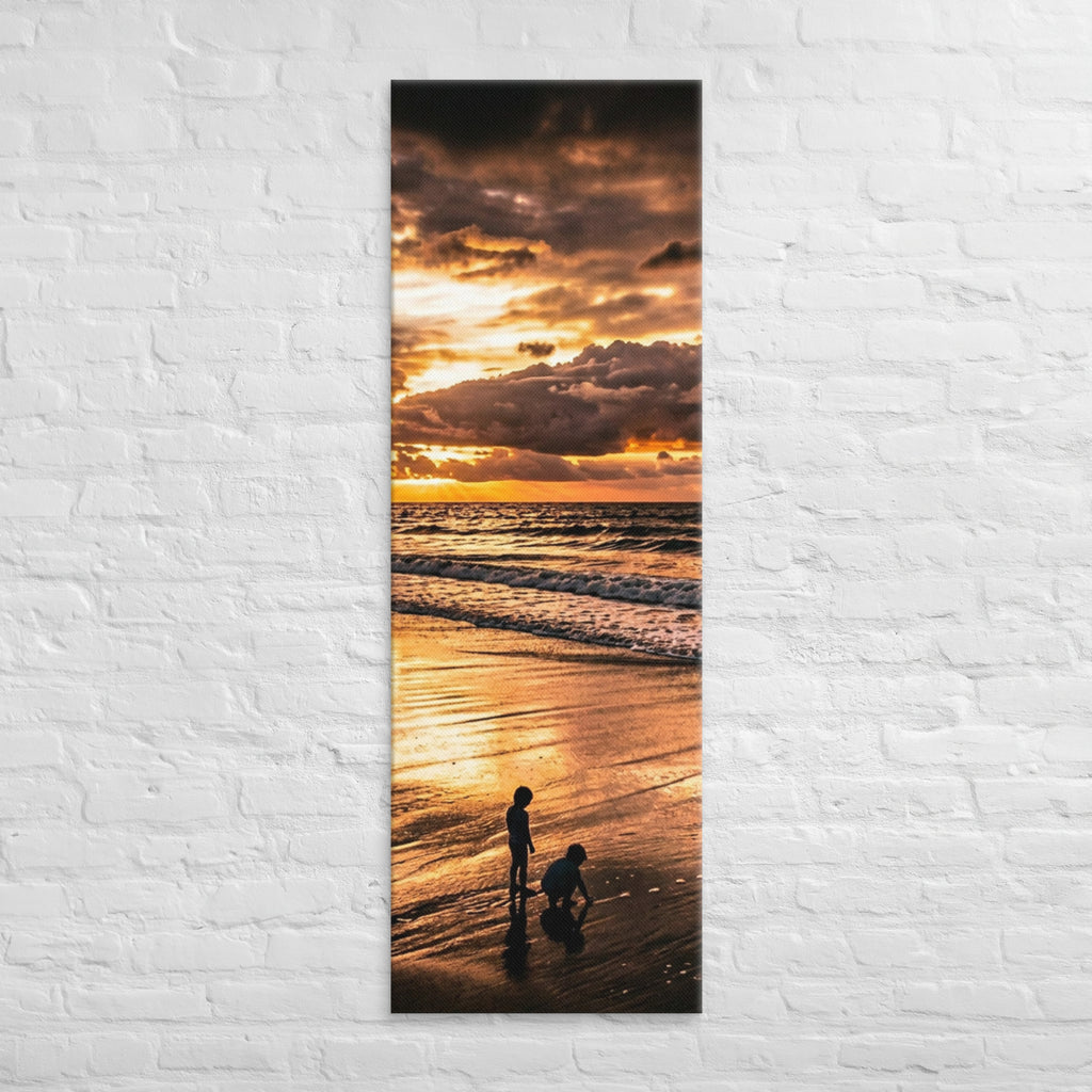 At the Water's Edge, tall wrapped canvas print: two figures on wet sand at the water's edge under a blazing golden sunset.