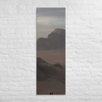 The Desert Stillness, tall wrapped canvas print: three figures in a vast hazy desert with a lone mesa in the distance.
