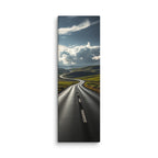 Through The Green Folds, tall wrapped canvas print: a winding road through green rolling hills under towering white cumulus clouds.