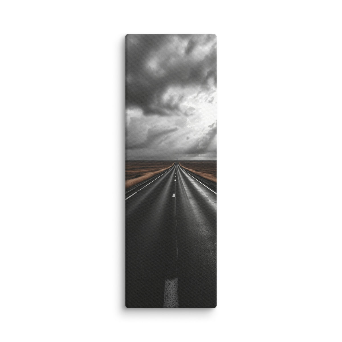 The Weight Of Weather, tall wrapped canvas print: a near-monochrome view of a road beneath an immense wall of dark storm clouds.