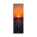 The Horizon Burns, tall wrapped canvas print: a road running straight into a blazing orange-red sunset, red light flooding the asphalt.