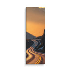 Borrowed Fire, tall wrapped canvas print: a switchback mountain road at golden hour with the asphalt catching warm fire-gold light.