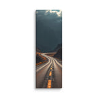Beneath The Dark Summit, tall wrapped canvas print: a winding road through a dark mountain valley beneath brooding blue-grey peaks.