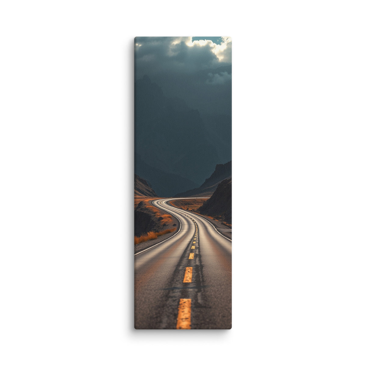 Beneath The Dark Summit, tall wrapped canvas print: a winding road through a dark mountain valley beneath brooding blue-grey peaks.