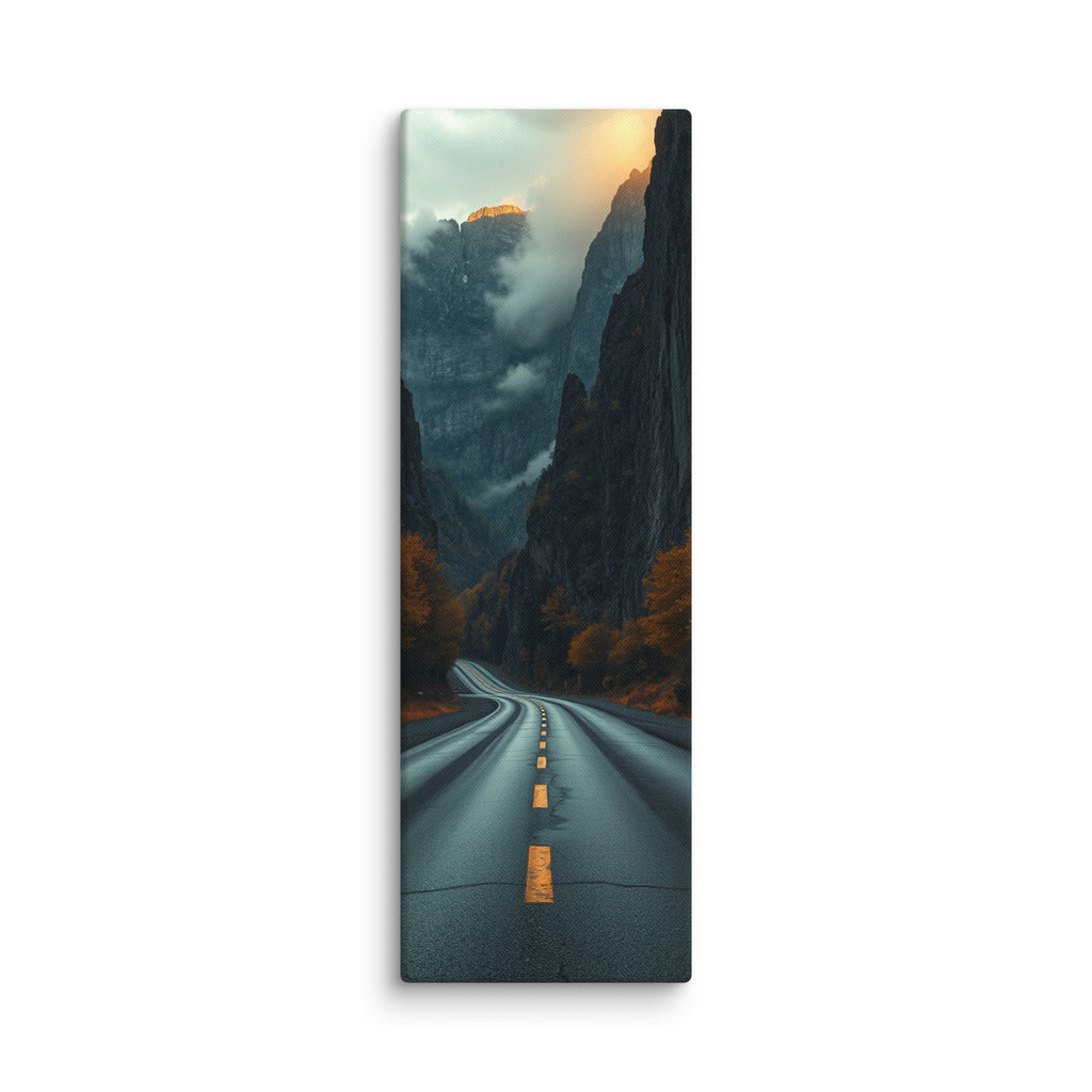 Into The Hidden Pass, tall wrapped canvas print: a road running into a dark gorge between towering cliffs with a sunlit golden peak above the mist.