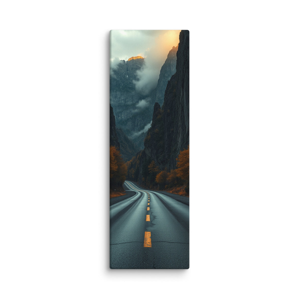 Into The Hidden Pass, tall wrapped canvas print: a road running into a dark gorge between towering cliffs with a sunlit golden peak above the mist.