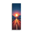 A Valley Of Fire, tall wrapped canvas print: a road running straight into a blazing red-orange sunset between snow-dusted mountains.