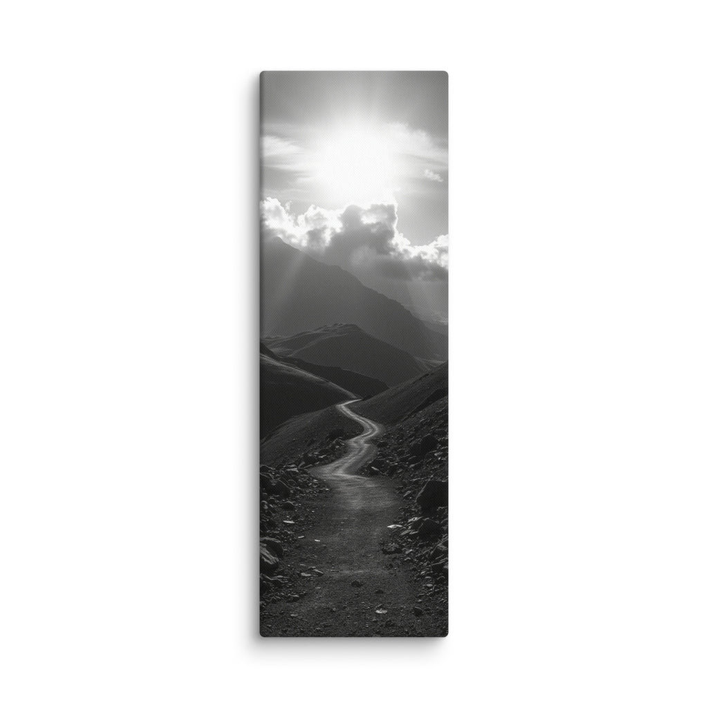 The Silent Ascent, tall wrapped canvas print: a black-and-white winding mountain path climbing toward sunlight breaking through clouds.
