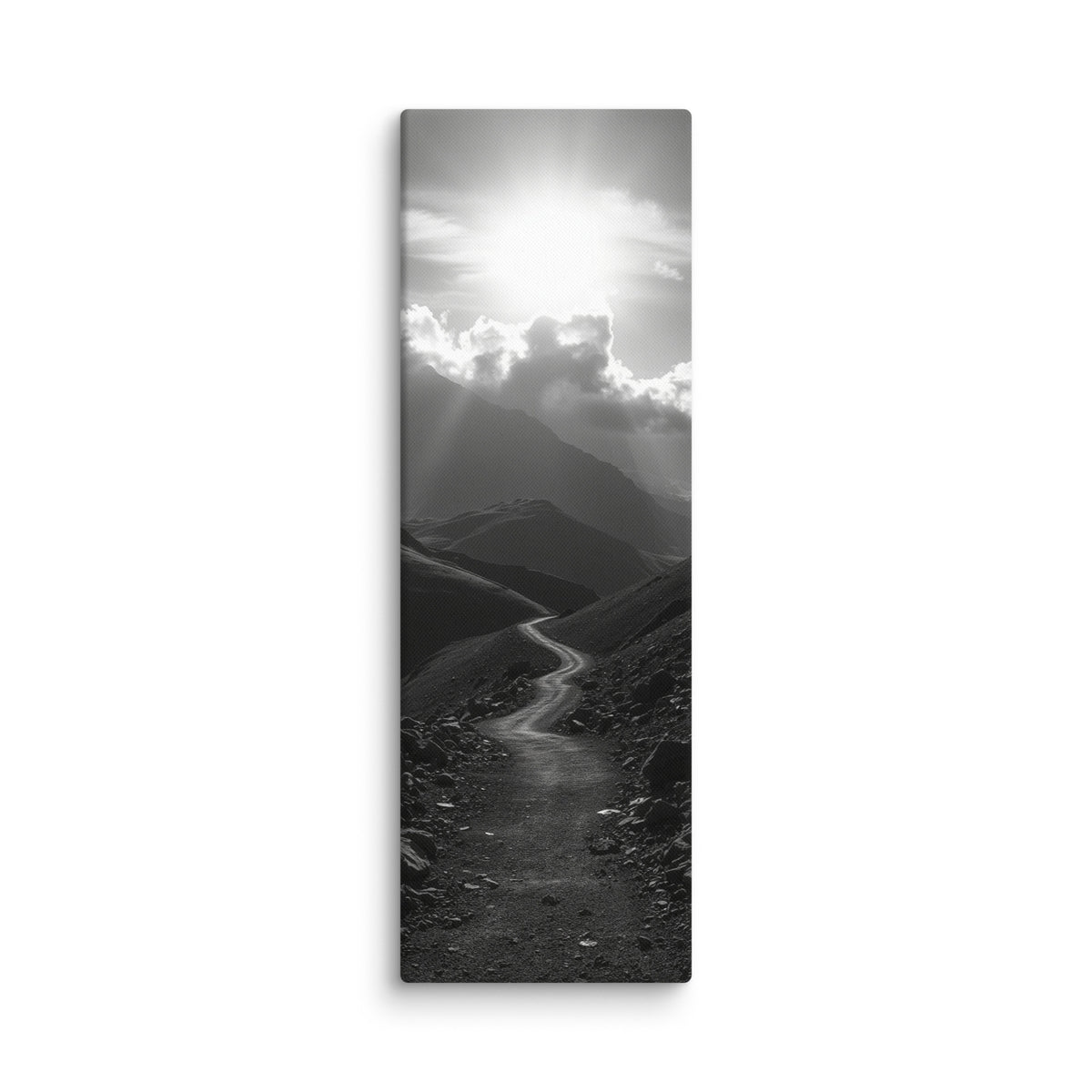 The Silent Ascent, tall wrapped canvas print: a black-and-white winding mountain path climbing toward sunlight breaking through clouds.