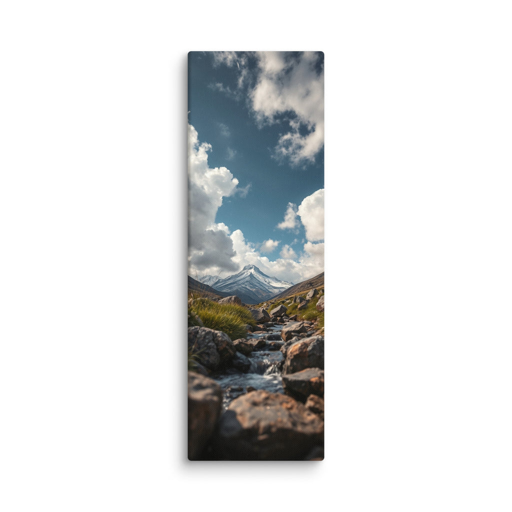 An Answer From The Mountains, tall wrapped canvas print: a rocky stream flowing toward a snow-capped mountain under dramatic clouds.