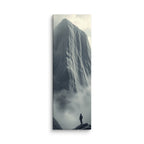 Above The Veil, tall wrapped canvas print: a lone figure on dark rocks gazing up at a massive grey ice cliff dissolving into mist.