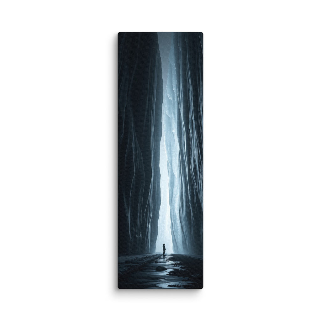 A Blade Of Light, tall wrapped canvas print: a vertical shaft of icy light cutting through a dark slot canyon with a lone figure.