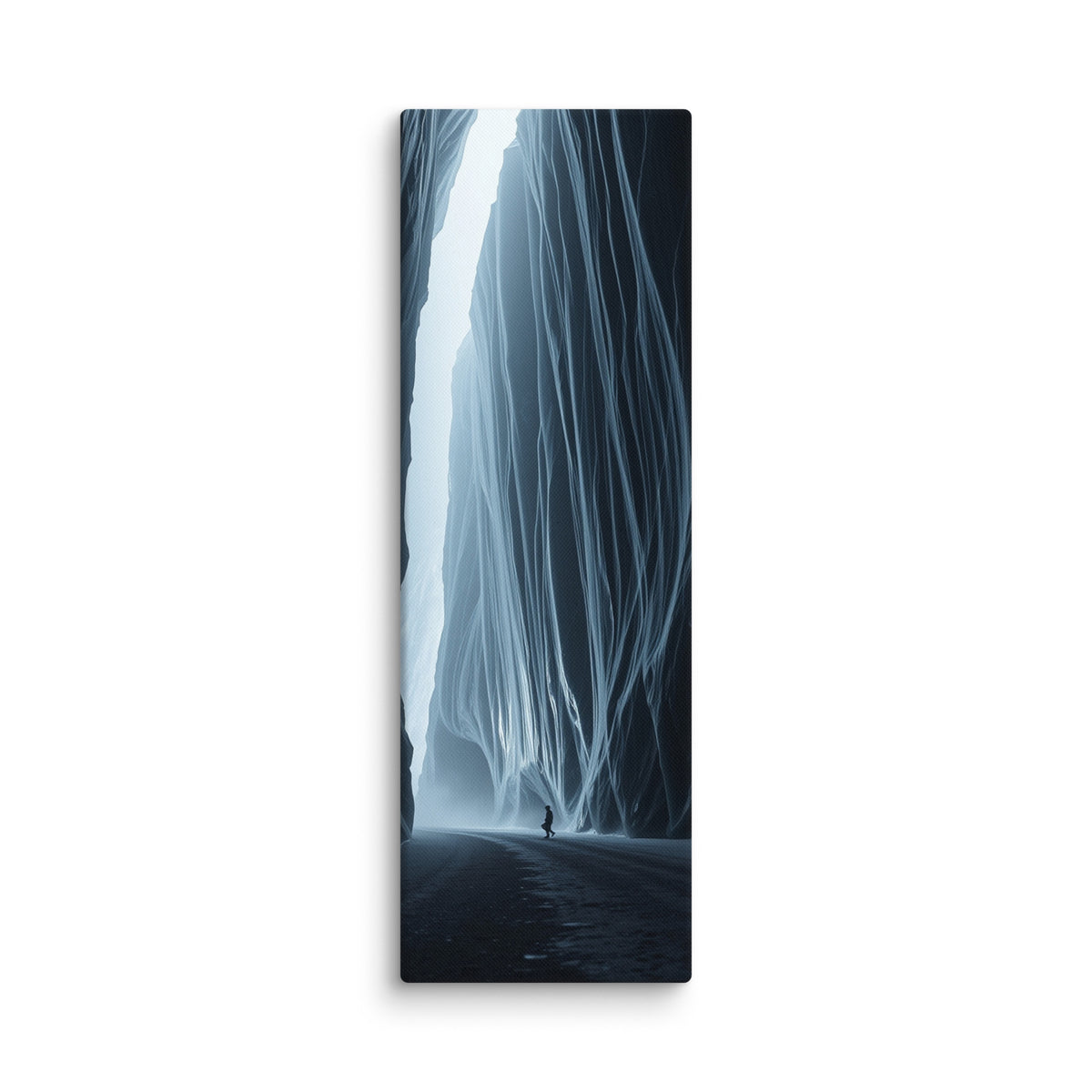 Blue Interval, tall wrapped canvas print: a small figure walking beneath towering blue-black ice curtains with a shaft of white light breaking through.