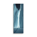 The Night Cleft, tall wrapped canvas print: footprints in snow leading to a lone figure before a luminous ice cleft at night.