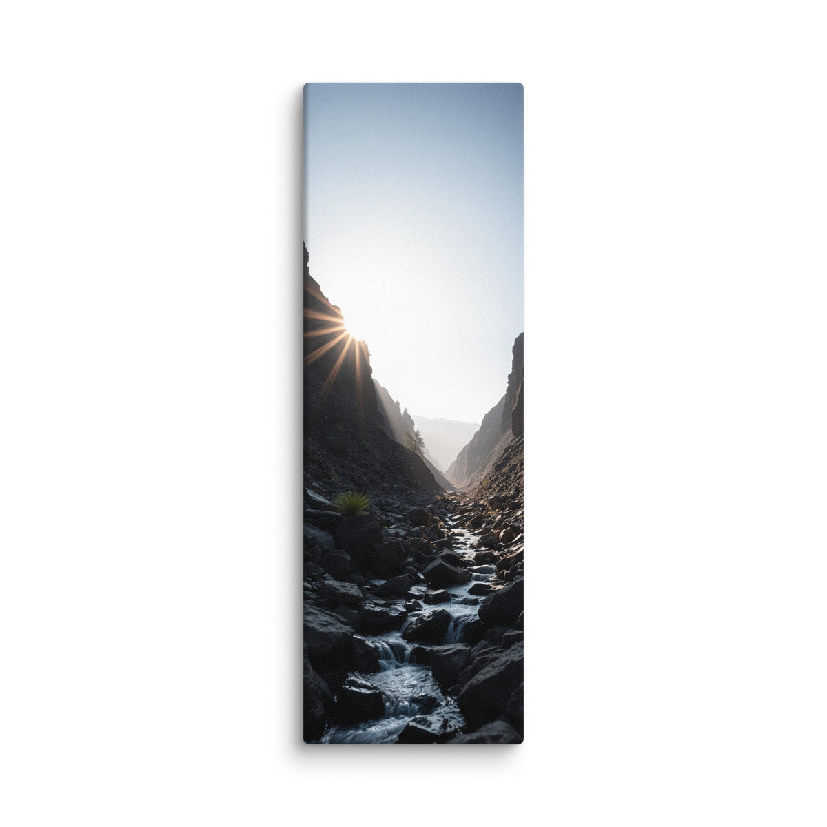 First Light In The Cleft, tall wrapped canvas print: the sun bursting over a dark rocky cleft as a stream flows toward the light.